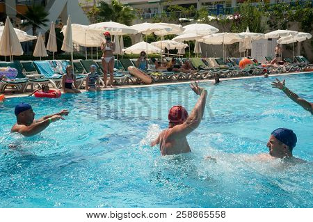 Turkler, Turkey - July 30, 2018: A Group Of People Playing In The Pool In A Water Polo Ball. Athlete