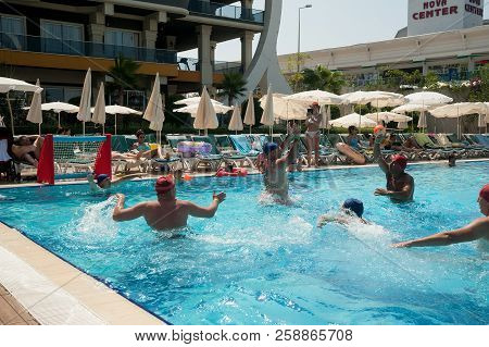 Turkler, Turkey - July 30, 2018: A Group Of People Playing In The Pool In A Water Polo Ball. Athlete