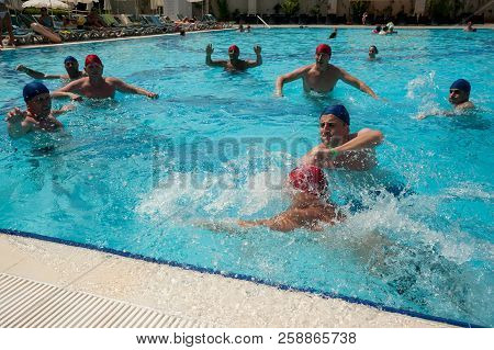 Turkler, Turkey - July 30, 2018: A Group Of People Playing In The Pool In A Water Polo Ball. Athlete