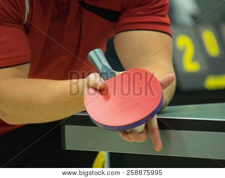 Table tennis player serving, close up