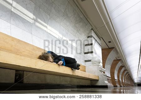 Homeless Man Sleeping On The Bench In The Subway