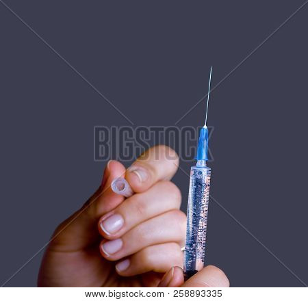 Hand With Open Medical Syringe, Isolated On Grey, Close-up