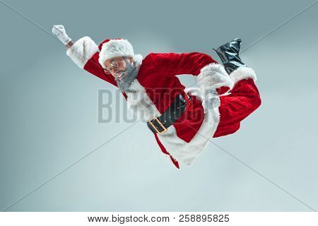 Funny Serious Guy With Christmas Hat Dancing At Studio. New Year Holiday. Christmas, X-mas, Winter, 