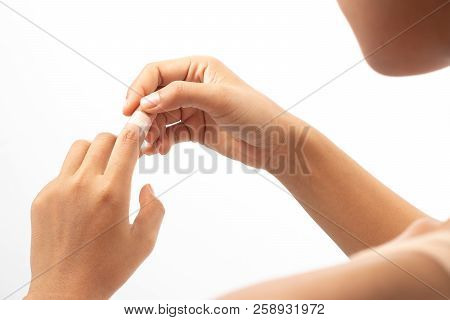 Woman Injured Finger And Using Bandage.