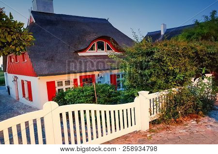 Traditional Thatched Roof House On A Sunny Summer Day At The Baltic Sea Near The Island Ruegen, Germ