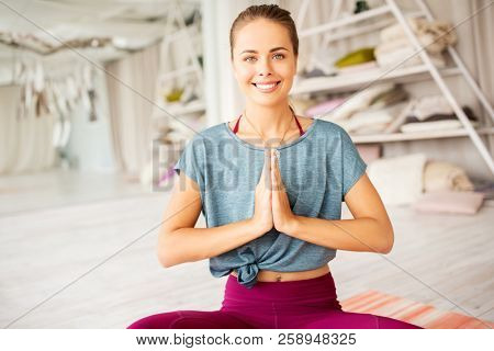 mindfulness, spirituality and healthy lifestyle concept - woman meditating in lotus pose at yoga studio