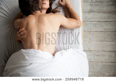 Passionate Young Couple Making Love On White Bed