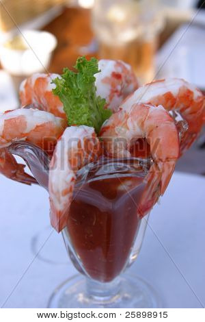 Appetizer of Shrimp Cocktail with a slice of Lemon and a piece of Lettuce