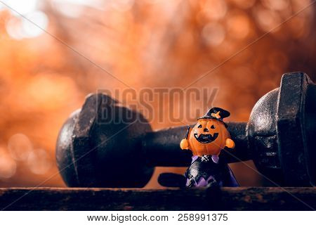 Halloween Festival Close Up Of Halloween Head Pumpkins Doll And The Black Iron Dumbbell. Fitness, He