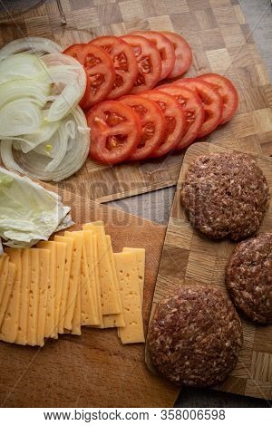Classic Gamburger With Tomato On Wooden Board