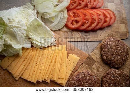 Classic Gamburger With Tomato On Wooden Board