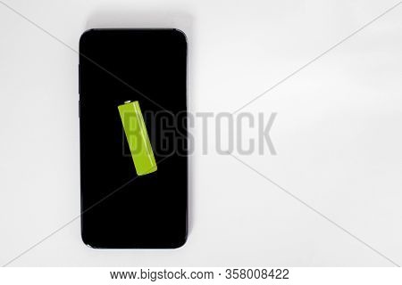 Mobile Phone Charging Concept. Smartphone And Green Batteries On The White Background