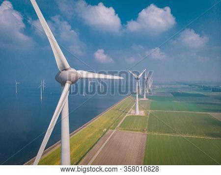 Wind Turbine From Aerial View, Drone View At Windpark Westermeerdijk A Windmill Farm In The Lake Ijs