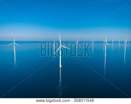 Wind Turbine From Aerial View, Drone View At Windpark Westermeerdijk A Windmill Farm In The Lake Ijs