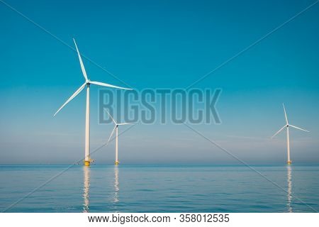 Wind Turbine From Aerial View, Drone View At Windpark Westermeerdijk A Windmill Farm In The Lake Ijs