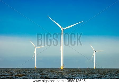 Wind Turbine From Aerial View, Drone View At Windpark Westermeerdijk A Windmill Farm In The Lake Ijs