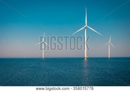 Wind Turbine From Aerial View, Drone View At Windpark Westermeerdijk A Windmill Farm In The Lake Ijs
