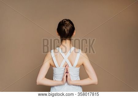 A Beautiful Young Girl Is Meditating In The Pose Of Parshvottanasana. Marichiasana. Consideration An