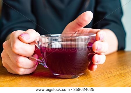 woman drinking Blue Butterfly Pea Tea