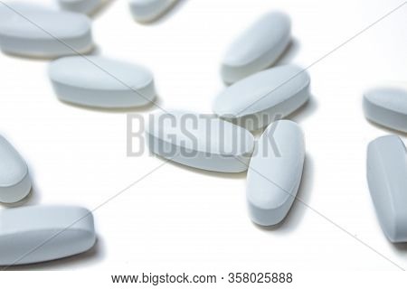 Tablets. Pills Background. Pills And Tablets In White On A White Background. Macro. Copy Space