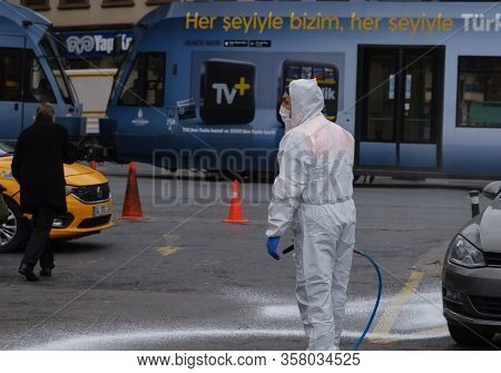 Istanbul, Turkey - 25 March, 2020:  A Man In Protective Equipment And Wearing A Mask And Cleaning Di