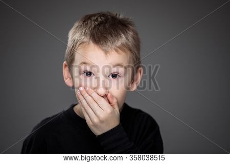 Grief-stricken little boy - feeling intense sorrow, remorse, sadnesss - studio portrait - vivid emotions series