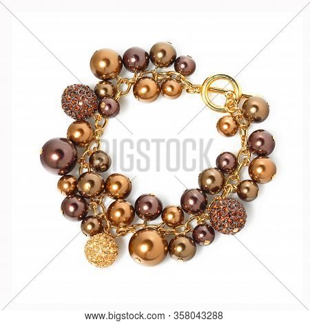 Women`s Wrist Bracelet Of Purple And Golden Beads On White 
Background. Top View