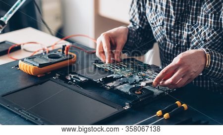 Tech Service. Computer Diagnostics. Male Engineer Working With Laptop Components.