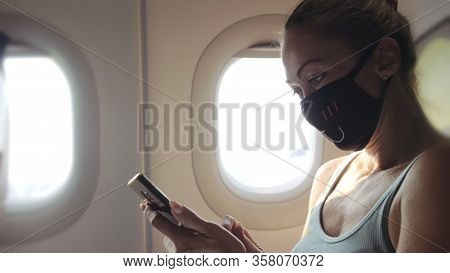 Woman Travel Tourist Caucasian At Plane Aircraft With Wearing Protective Medical Mask. Read Shock Ne