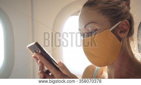 Woman Travel Tourist Caucasian At Plane Aircraft With Wearing Protective Medical Mask. Read Shock Ne