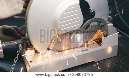 Working Man With Big Saw Cutting Metal. Grinding In Steel Manufactory. Iron Work Concept.