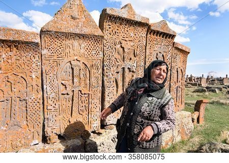 Noratus, Armenia-may, 01 2019: Unique Cemetery Of Khachkars, Old Armenian Woman Talk About Khachkars