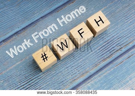 Concept Image A Wooden Block And Word - #wfh ( Work From Home ) On Wooden Background