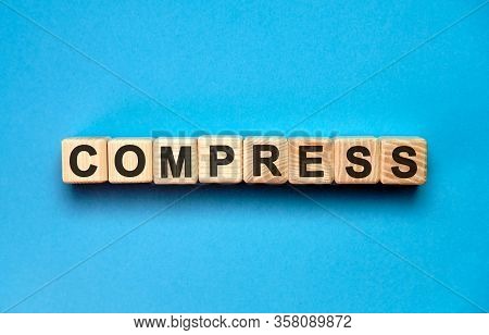 Compress Word Cube On A Blue Background. Medical Concept.