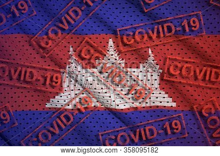Cambodia Flag And Many Red Covid-19 Stamps. Coronavirus Or 2019-ncov Virus Concept