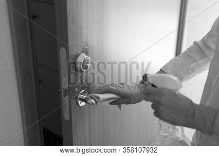 Cleaning Door With Sanitarizer - Womans Hand In Blue Medical Protective Glove With Rag Wiping Doors 