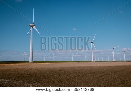 Offshore Windmill Farm In The Ocean Westermeerwind Park , Windmills Isolated At Sea On A Beautiful B