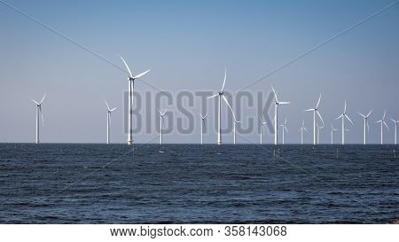 Offshore Windmill Farm In The Ocean Westermeerwind Park , Windmills Isolated At Sea On A Beautiful B
