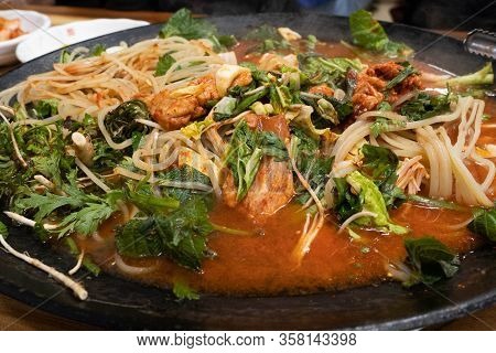 Close Up Image Korean Spicy Chicken Stir Fry, Dak Galbi, Being Boiled On A Traditional Big Pot With 