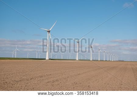 Offshore Windmill Farm In The Ocean Westermeerwind Park , Windmills Isolated At Sea On A Beautiful B