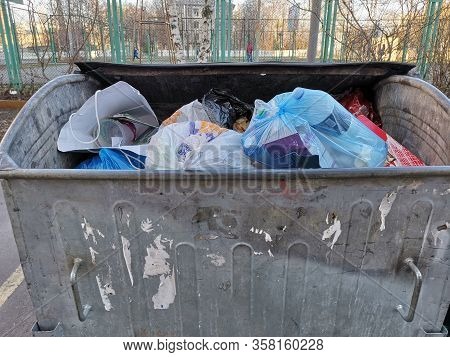 Outdoor Metal Garbage Bin. Steel Dumpster Container With Trash.