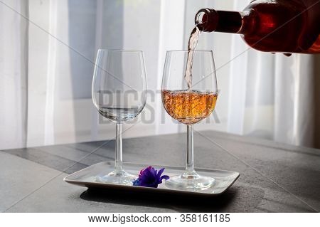 Pouring Of Rose Wine From Provence In Two Glasses In Sunny Day