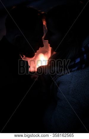 Winter Picnic On Baech With Bonfire. Love Story On Winter Foggy Sand Beach. Drink Hot Tea In Cold We