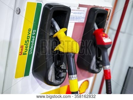Petrol Pump Filling Nozzles At Shell Gas Station