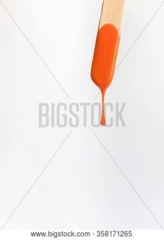 Orange Waxing  Wood On The White Background