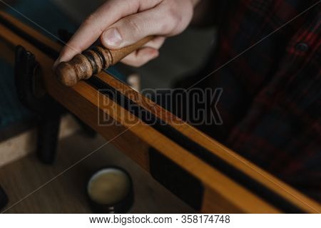 Man Hands Smoothing The Leather With The Special Instrument Photographed From The Top
