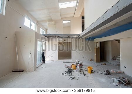 interior of construction site with scaffolding in a large modern unfinished duplex apartment