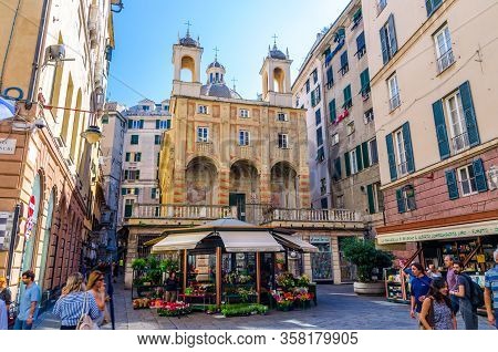 Genoa, Italy, September 11, 2018: People Are Walking Down Square With Small Church Chiesa Di San Pie