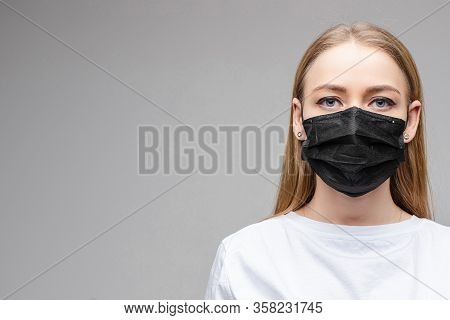 Woman In Black Aseptic Respirator. Corona Virus Protection Concept.