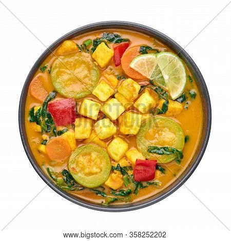A Yellow Veg Thai Curry With Tofu And Vegetables Isolated On White Background. Vegetarian Thai Curry